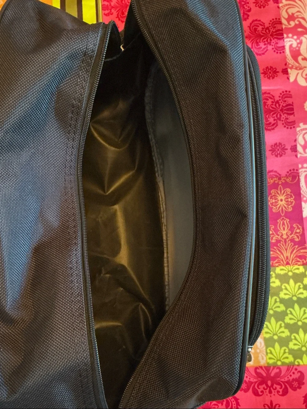 American Tourister Black Travel Duffel Bag - Front Pocket, Back Attachment.